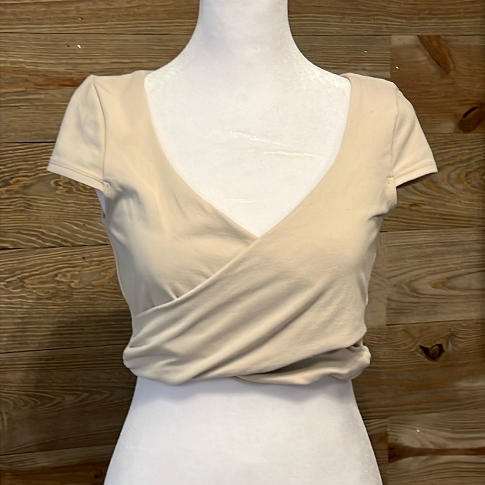 Bebe cream wrap crop top. Short sleeves. Medium